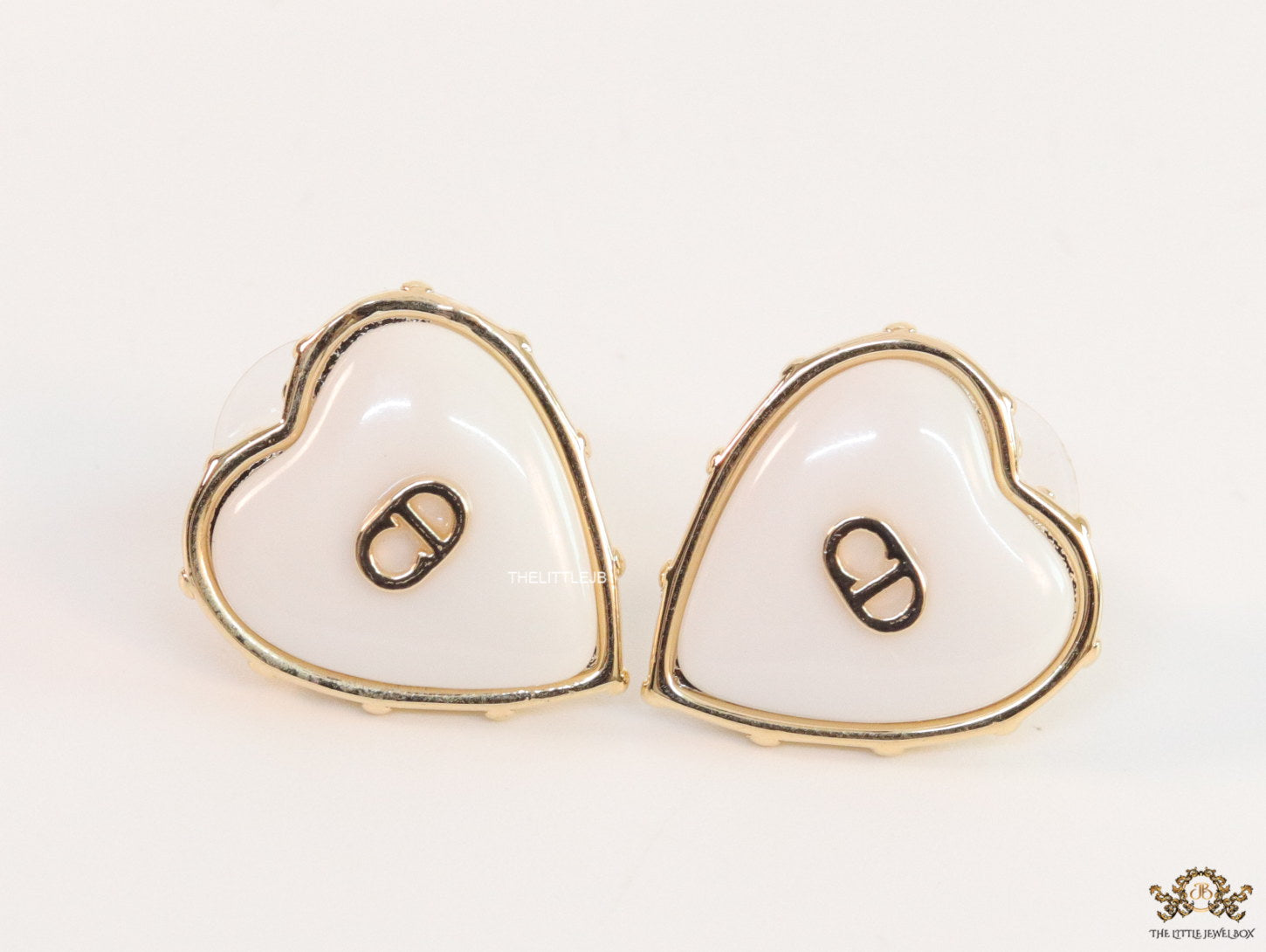 Heart shape white stud earrings with golden alphabets