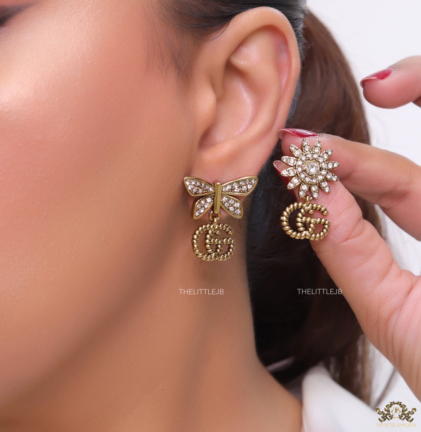 Flower and butterfly cz earrings in antique gold with twin G drops