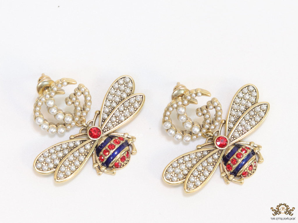 Pearl twin G earrings with pearl and multi cz bees in golden finish