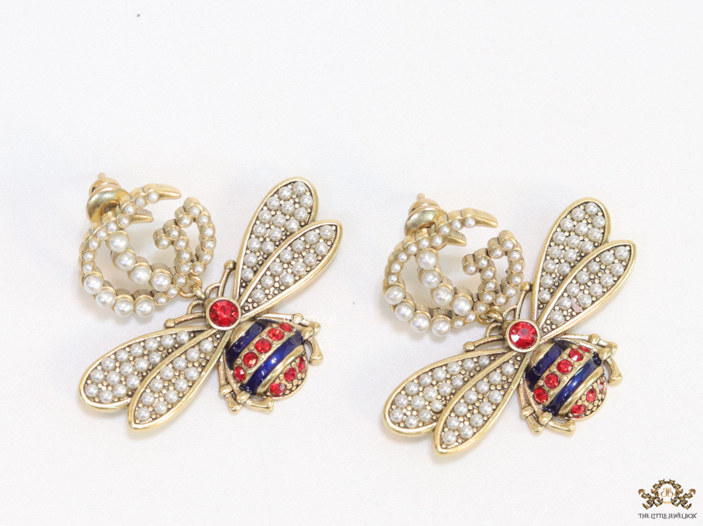 Pearl twin G earrings with pearl and multi cz bees in golden finish