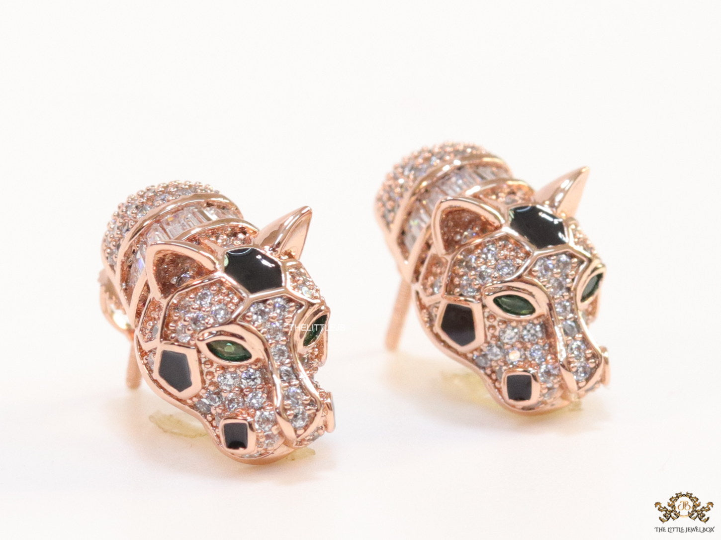 Asymmetrical cz and baguette panther studs in rose gold finish