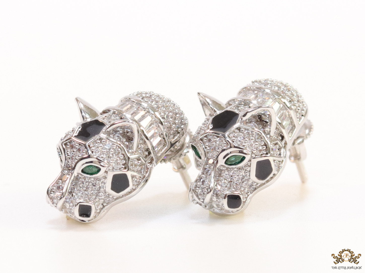 Asymmetrical cz and baguette panther studs in platinum finish
