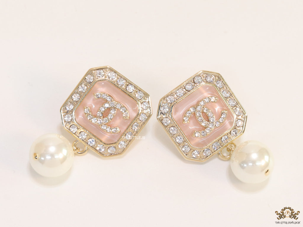 Light pink pearl drop earrings with twin C motif in cz