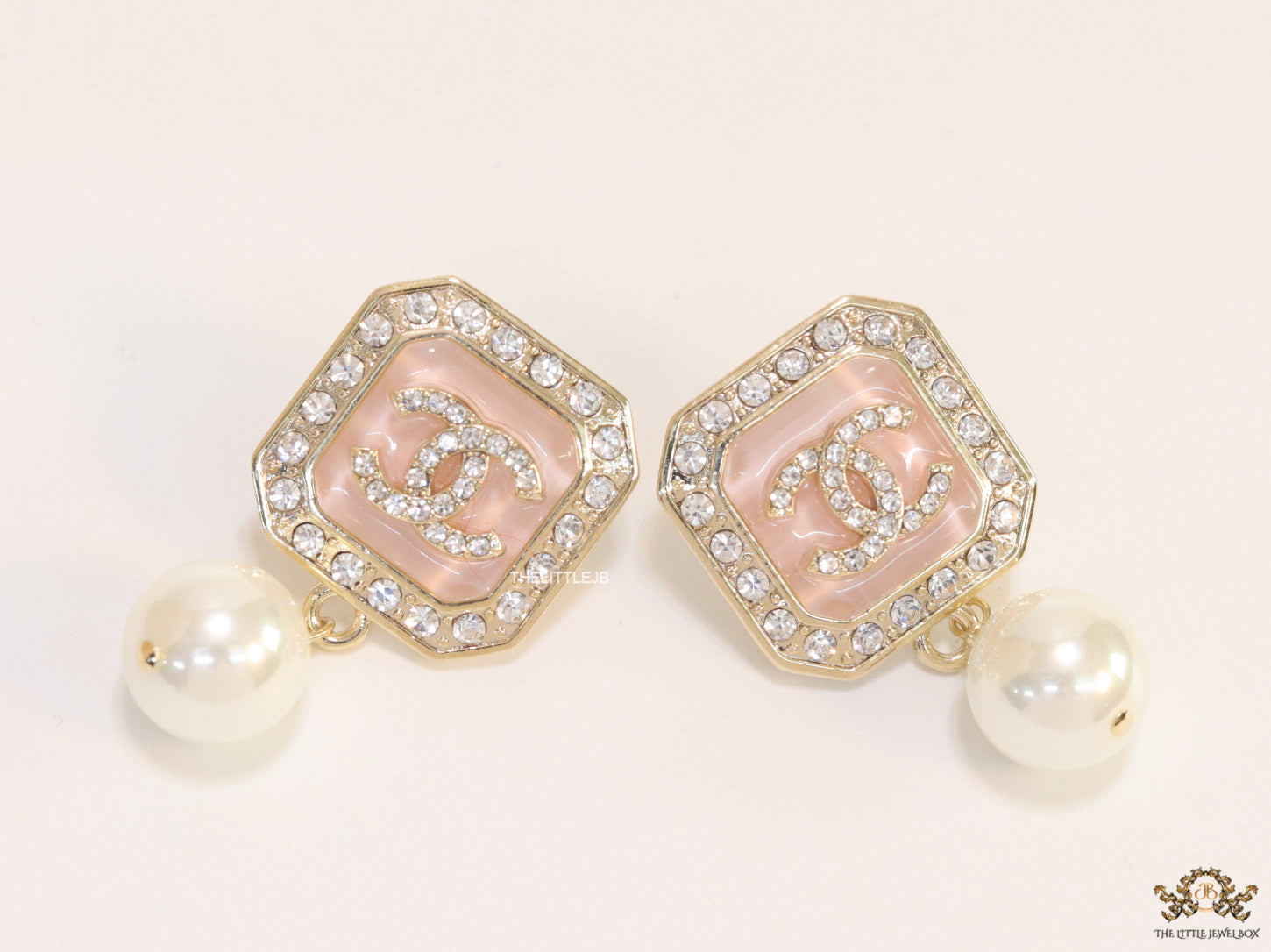 Light pink pearl drop earrings with twin C motif in cz
