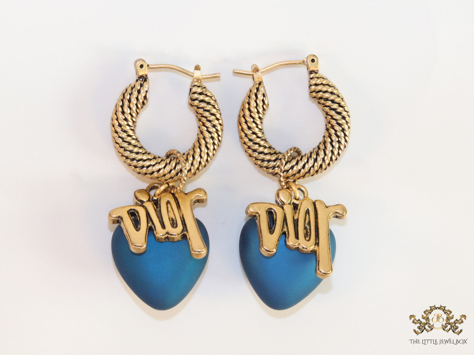 Golden hoops with alphabets and blue pearl drop