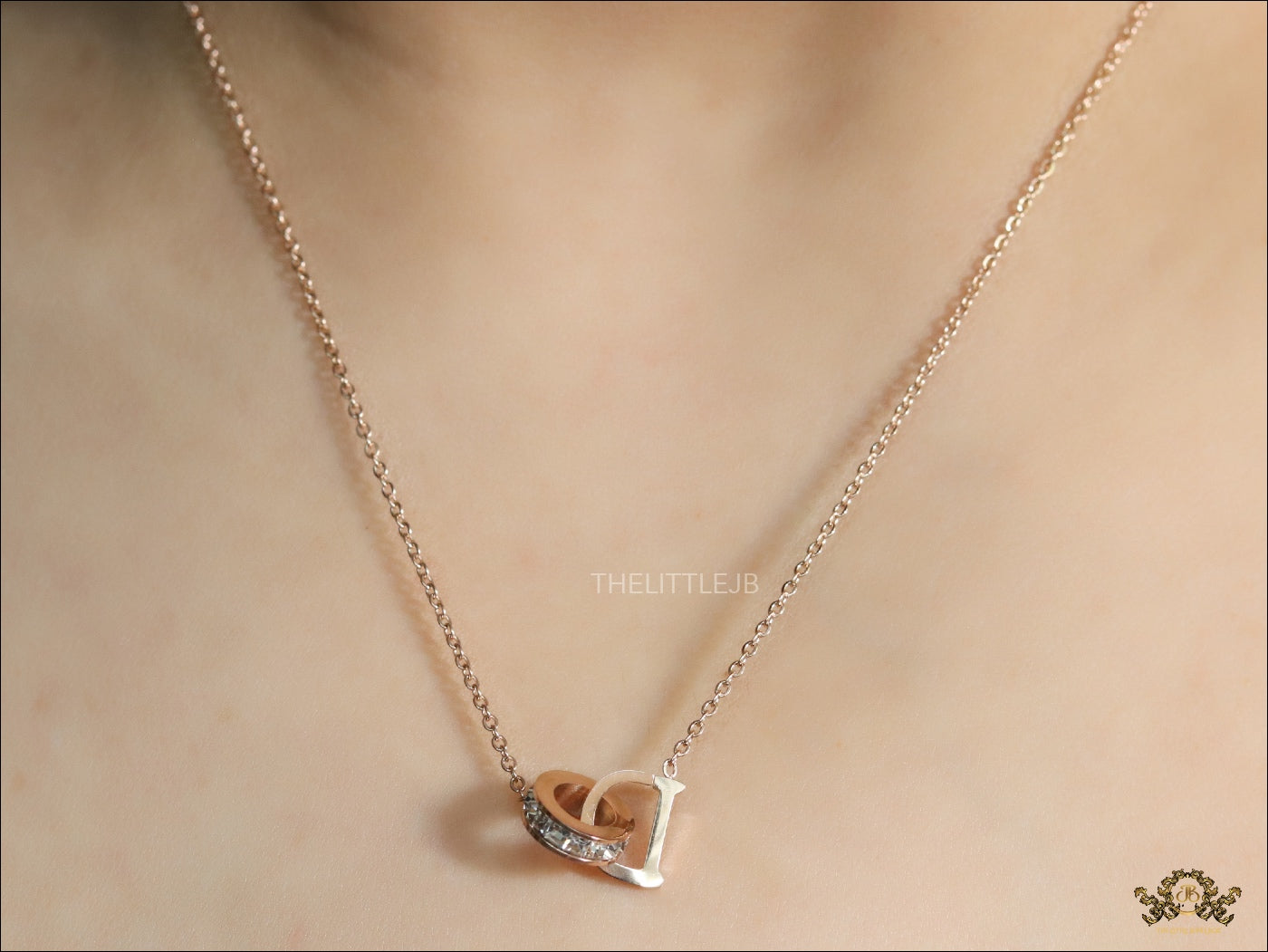 Rose gold plated D initial necklace with interlocking cz ring