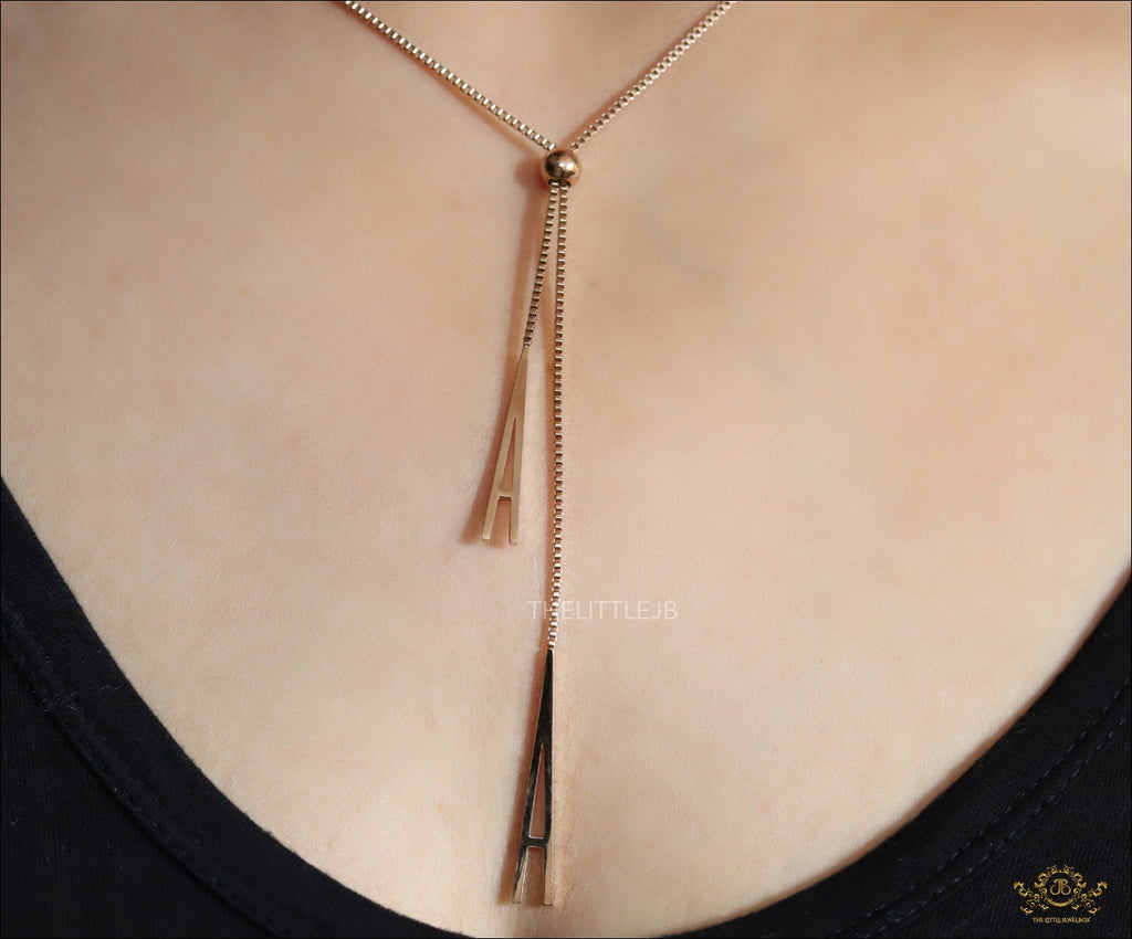 A initial sling necklace in gold finish