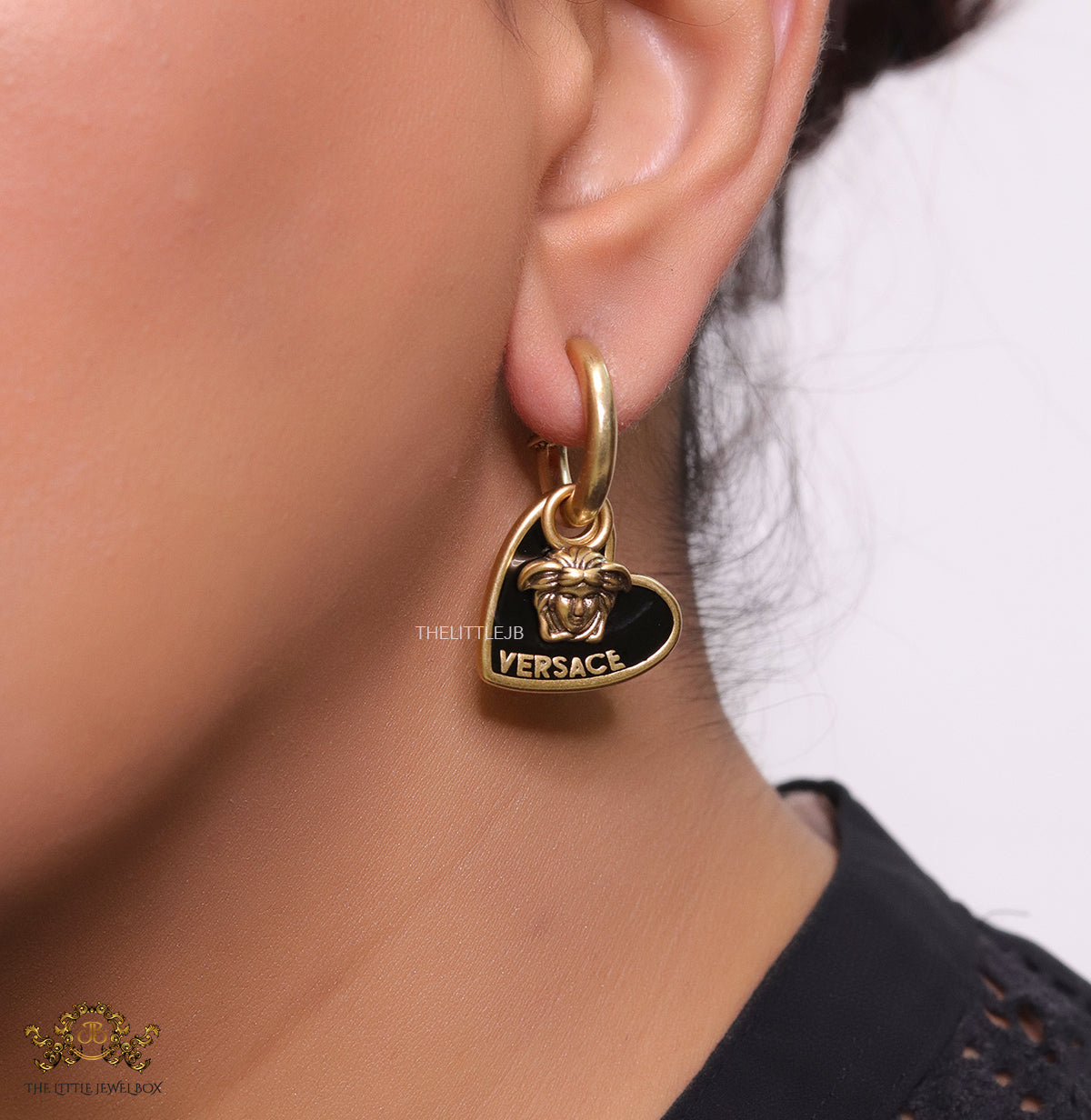 Golden and black enamel heart shape medusa earrings