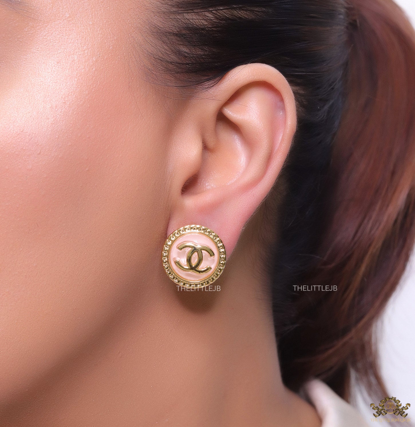 Twin C motif gold plated round studs on pink acrylic base