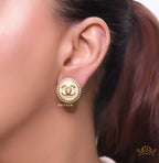 Twin C motif gold plated round studs on pearly cream acrylic base