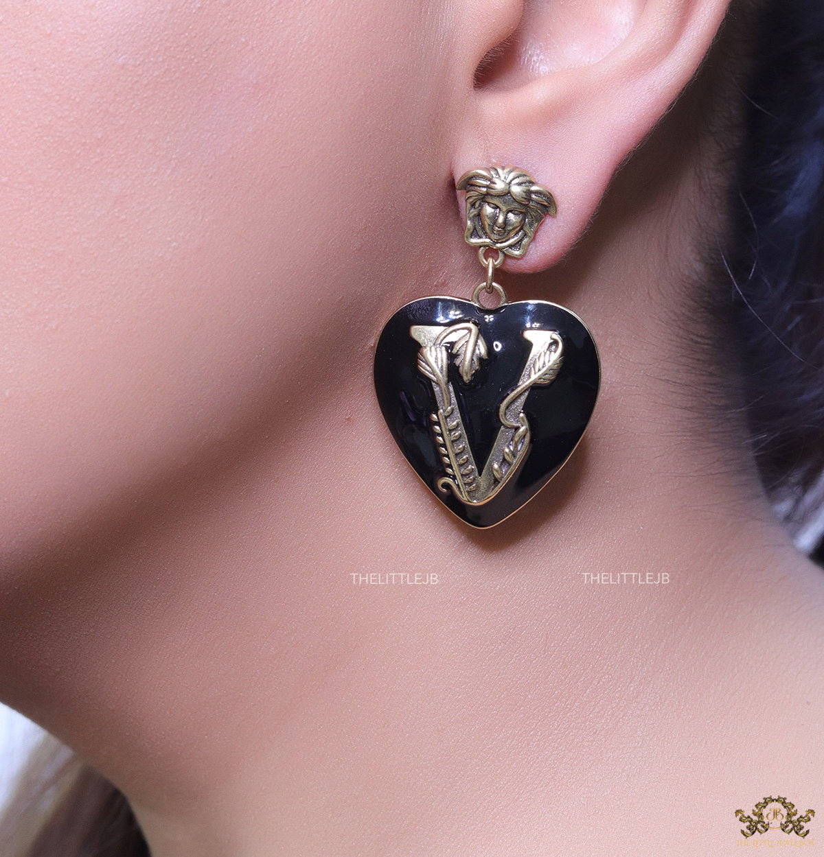 Gold plated medusa earrings with V motif black heart shape drop