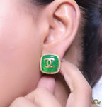 Green twin C motif stud earrings in golden finish