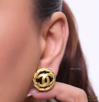Twin C motif matt gold plated round studs on black base