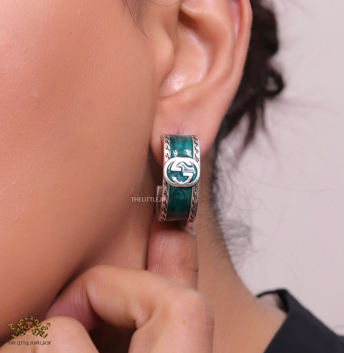 Blue green platinum studs with twin G motif