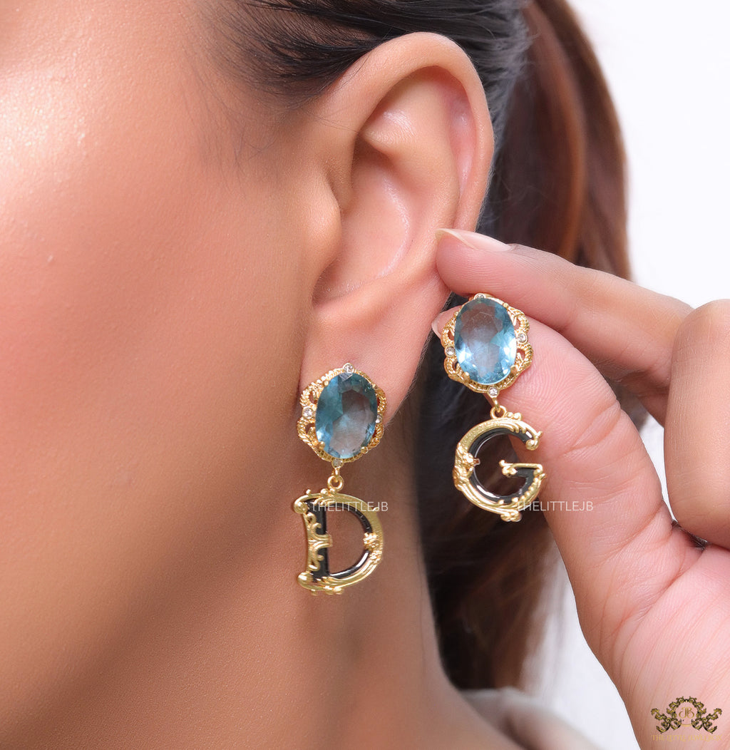 Semi-precious blue stone with gold plated detailed with black and golden alphabet drop