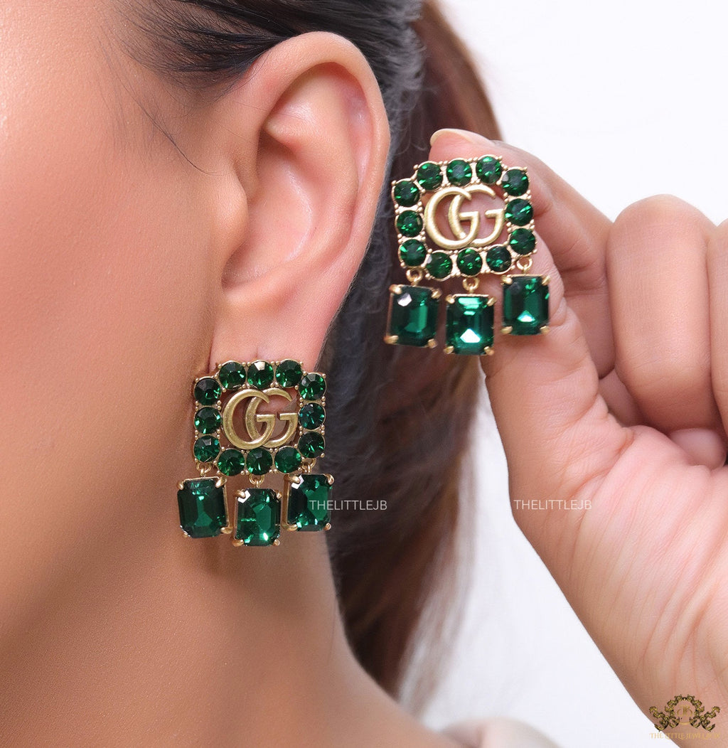 Emerald Green stone studs with gold plated double G motif and emerald green stone drop
