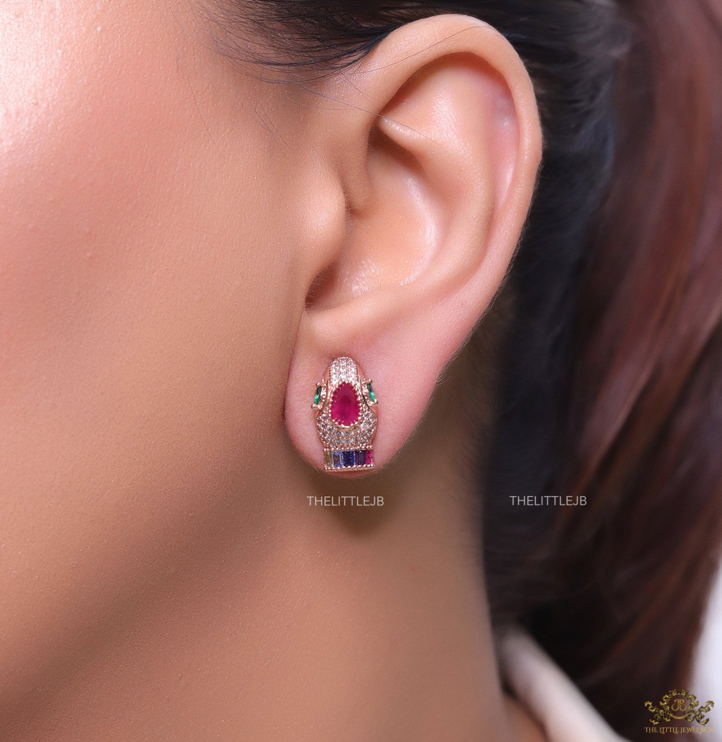 Rose gold plated serpentine head stud earrings with multi color cz