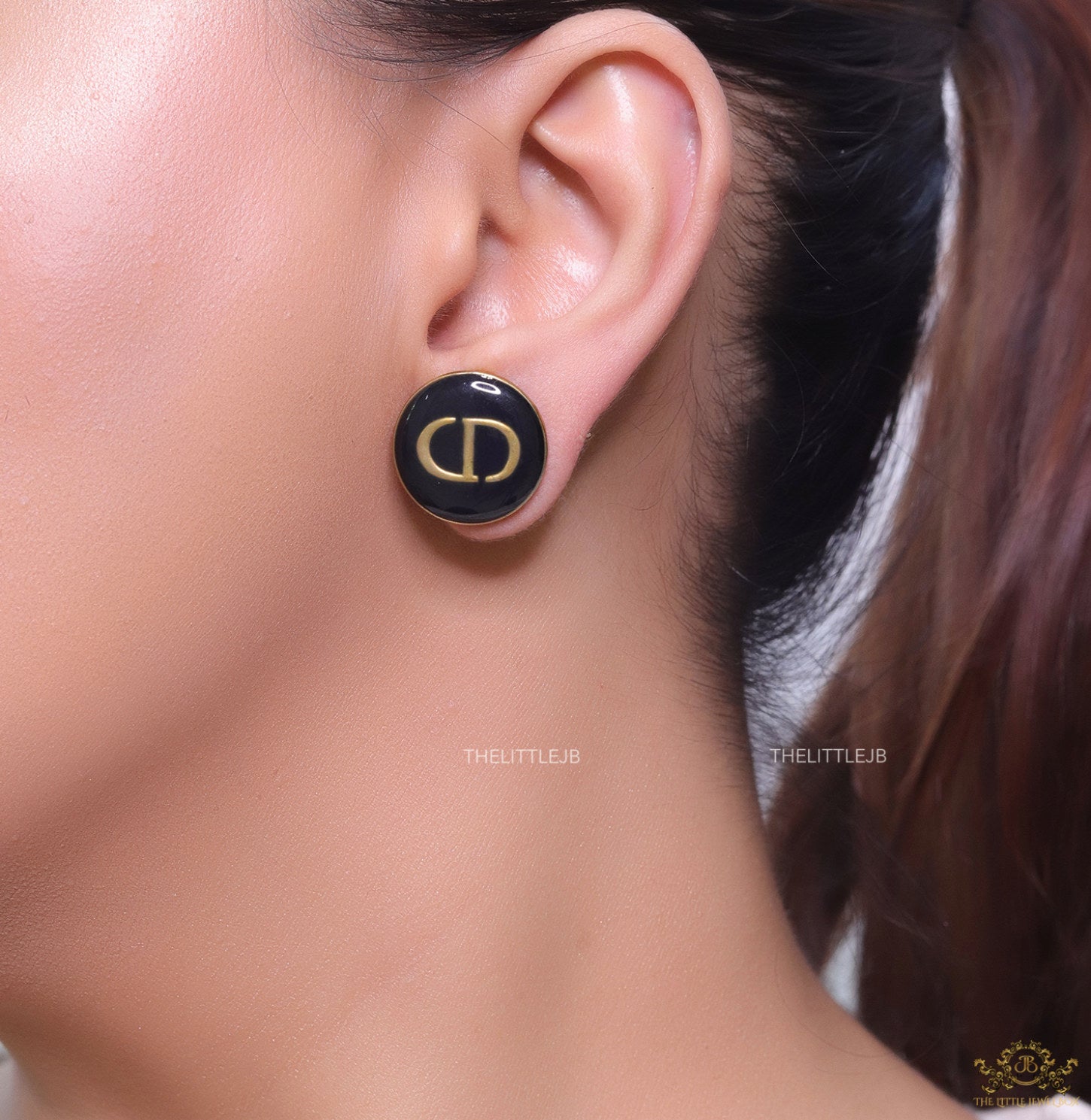 Round black stud earrings with golden alphabets