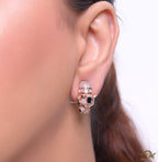 Asymmetrical cz and baguette panther studs in rose gold finish
