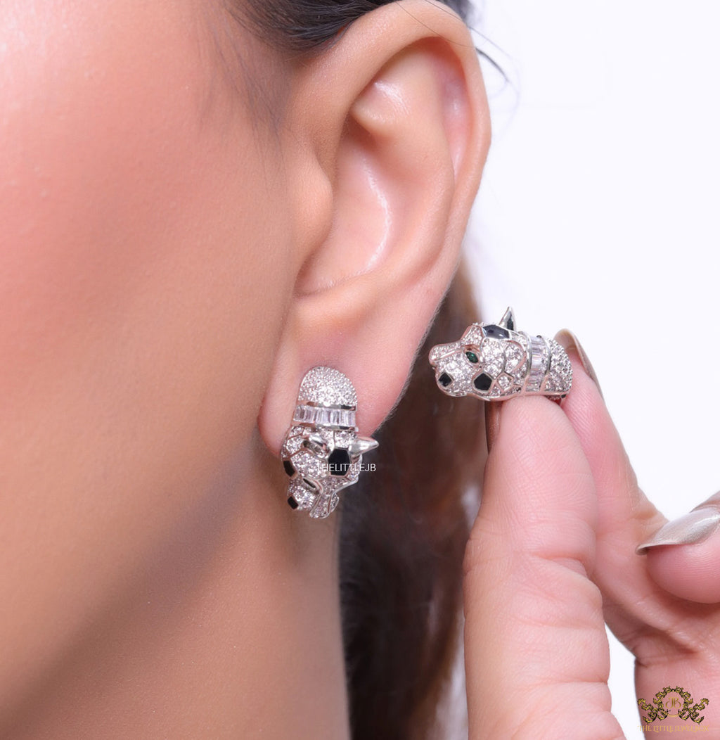 Asymmetrical cz and baguette panther studs in platinum finish
