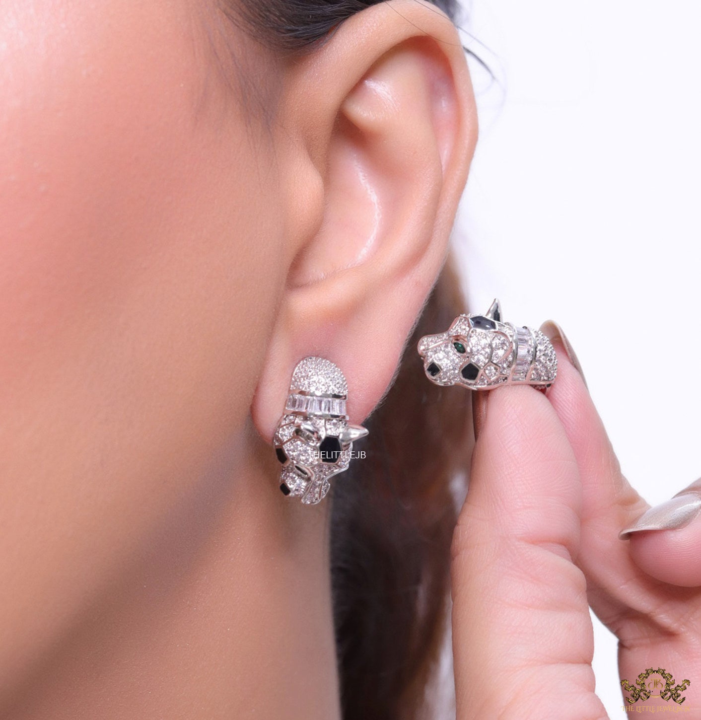 Asymmetrical cz and baguette panther studs in platinum finish