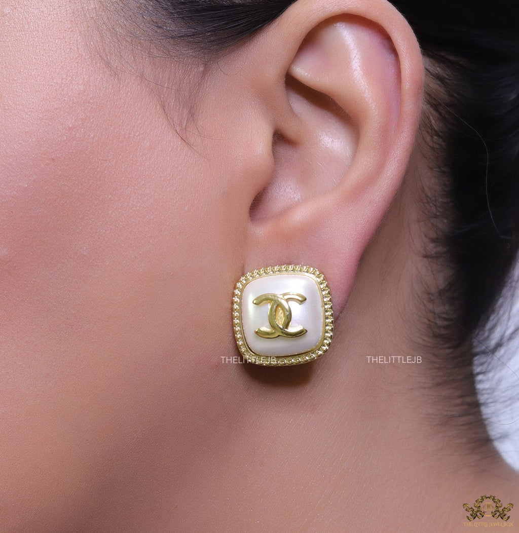 Twin C motif square studs in golden and MOP finish