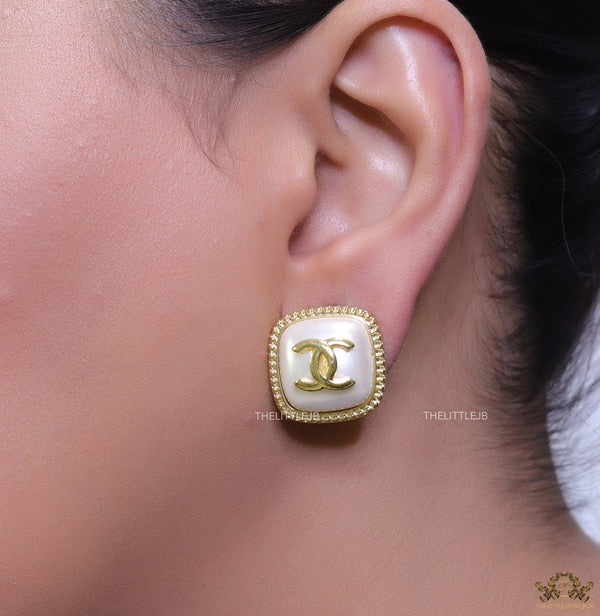 Twin C motif square studs in golden and MOP finish
