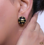 Black and golden twin C motif round stud earrings