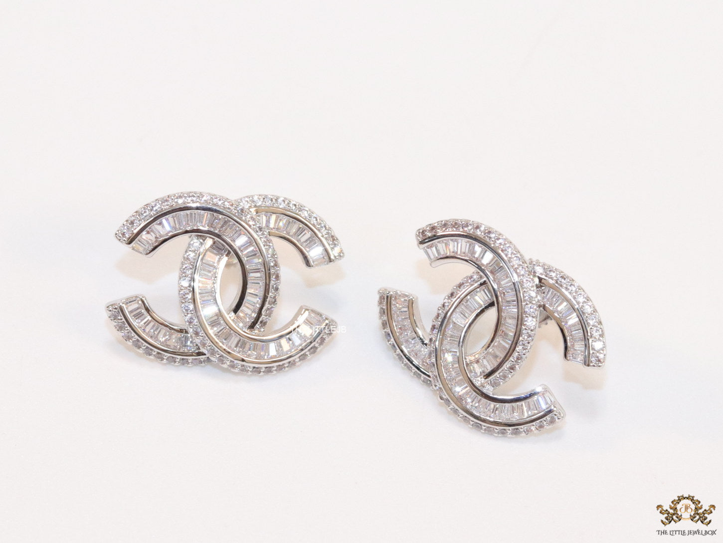 Platinum plated cz studs in twin C motif