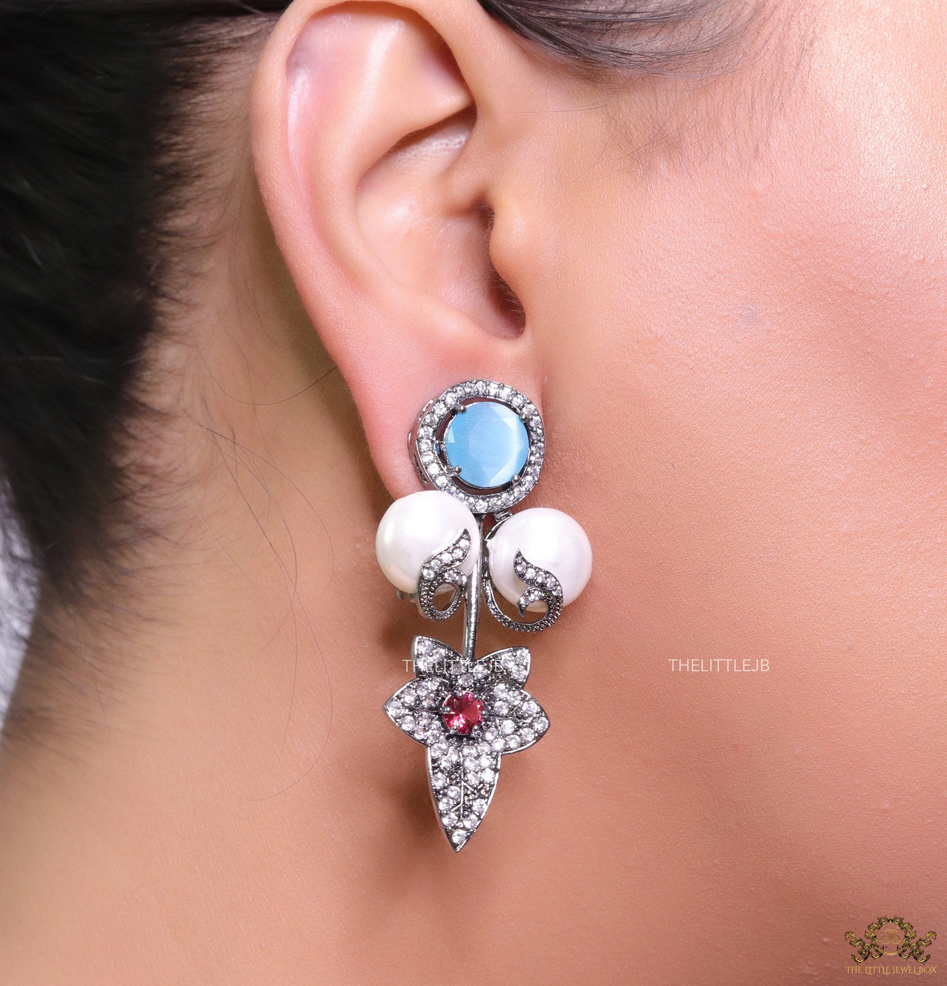 Cz flower earrings with shell pearls and light blue stones