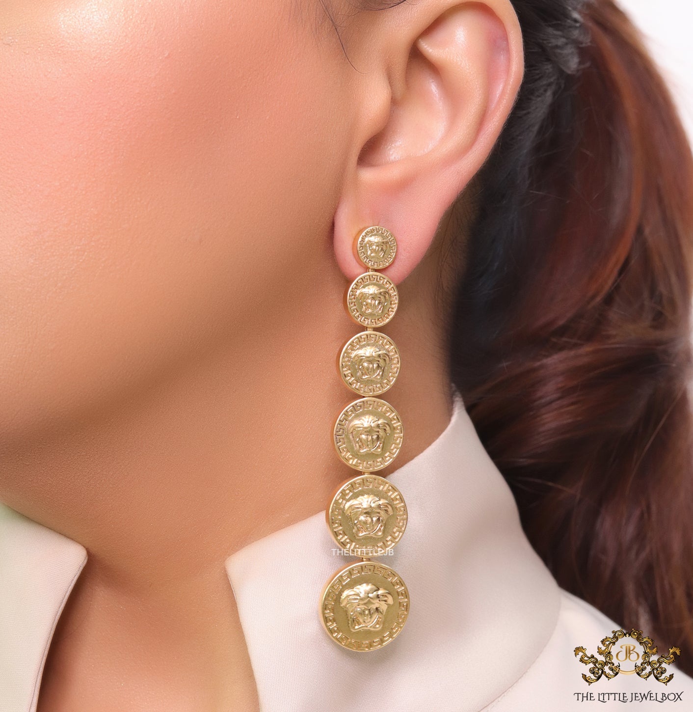 Gold plated embossed Medusa motif on golden circular base with golden details long chain studs