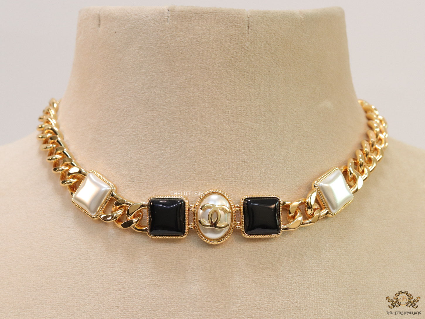 Gold plated link chain choker with MOP and black stone units.