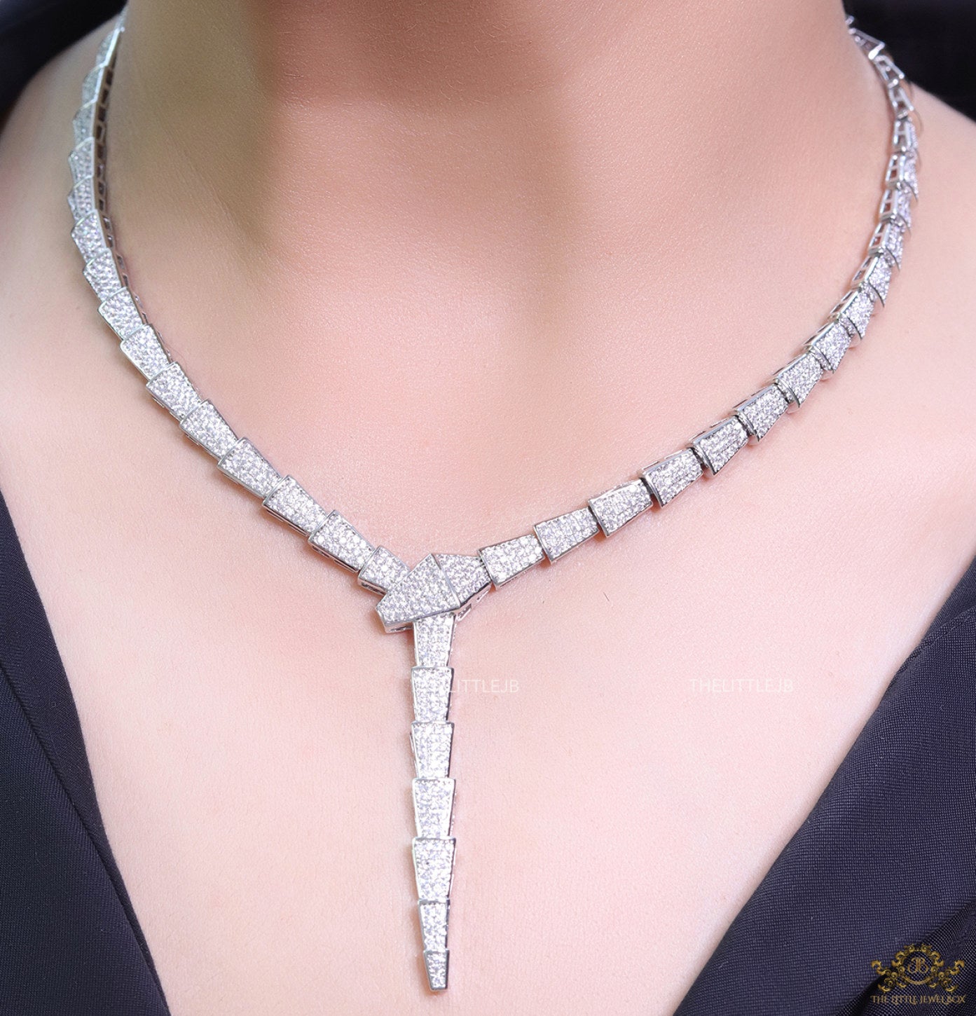 Platinum plated serpentine look knot necklace in cz