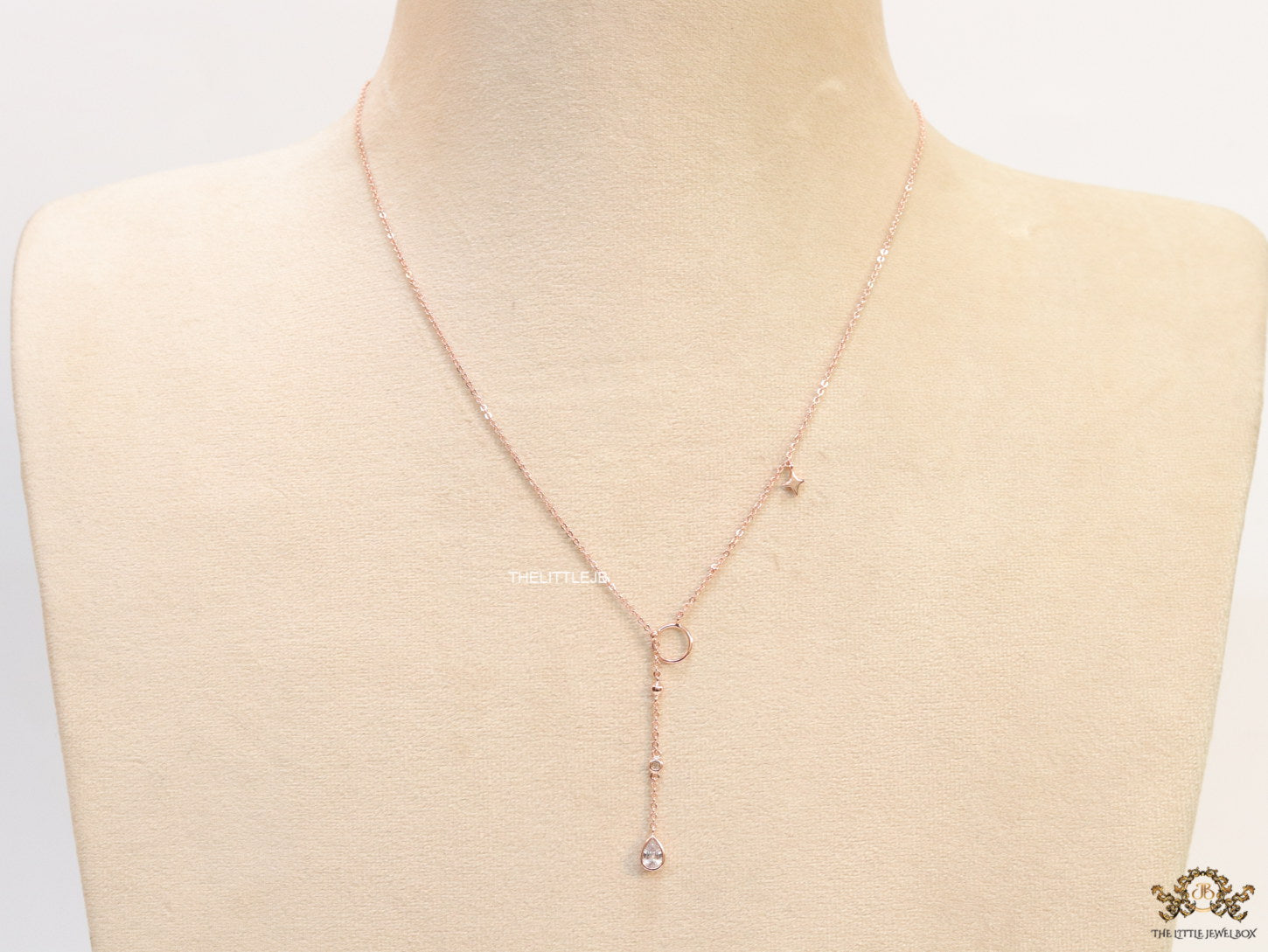Platinum knot necklace with cz drop and small charms
