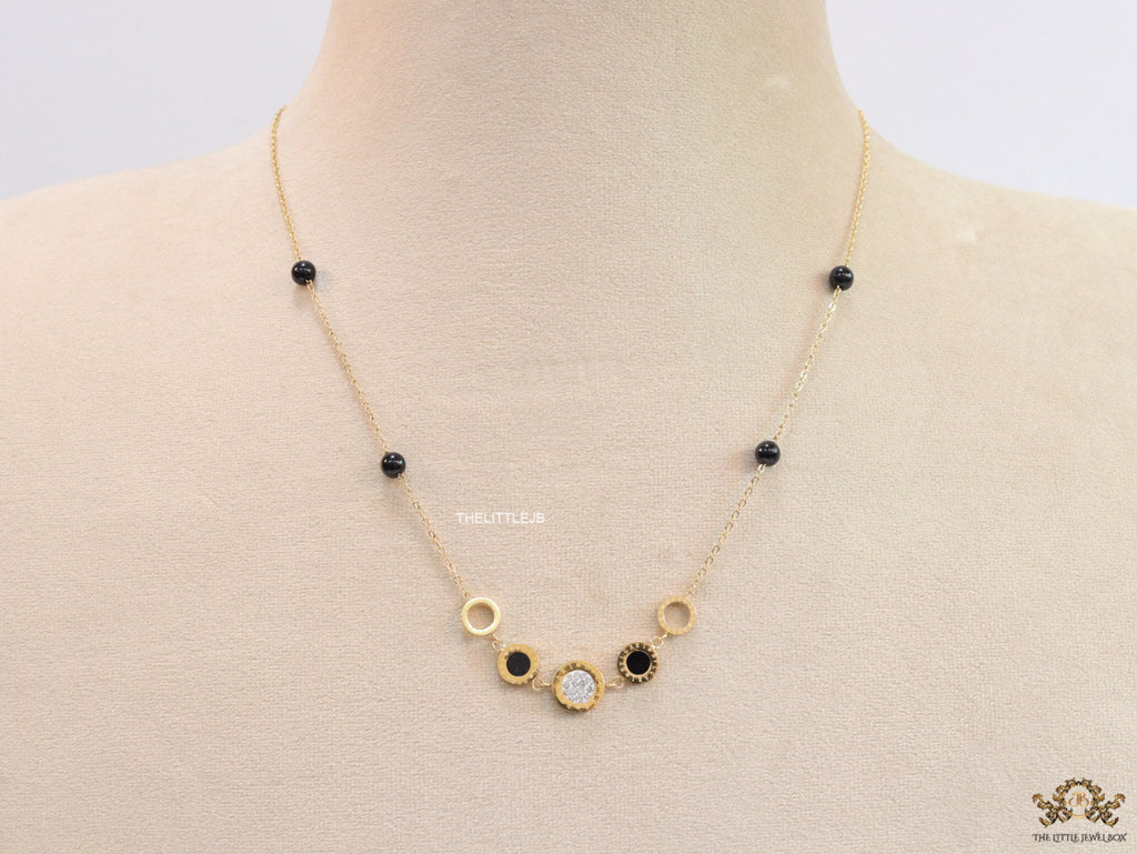Golden chain necklace with black beads and golden alphabet discs, cz and more