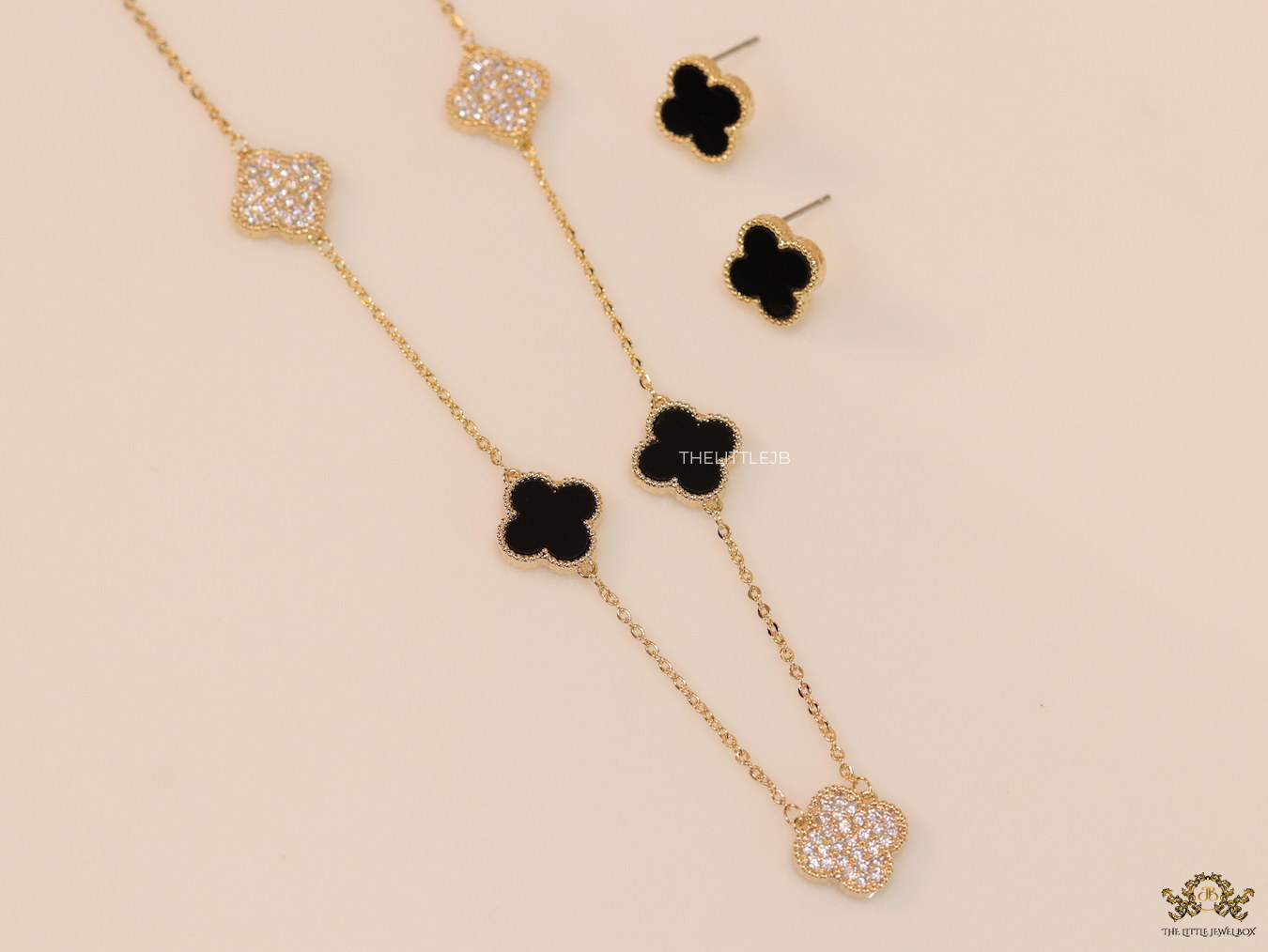 Gold plated necklace set with cz and black enamel coated clovers