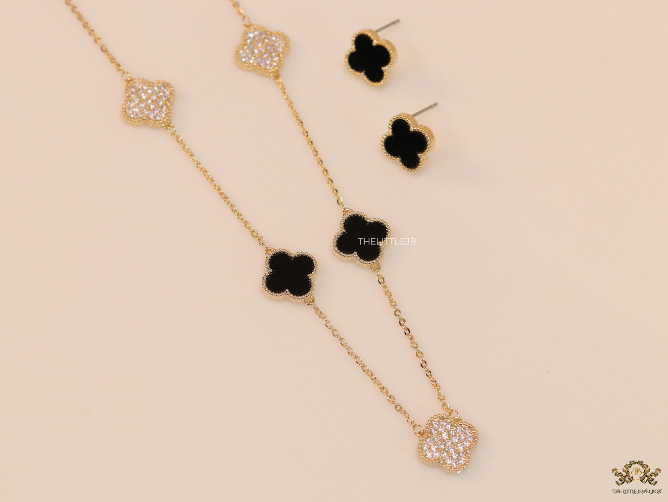 Gold plated necklace set with cz and black enamel coated clovers