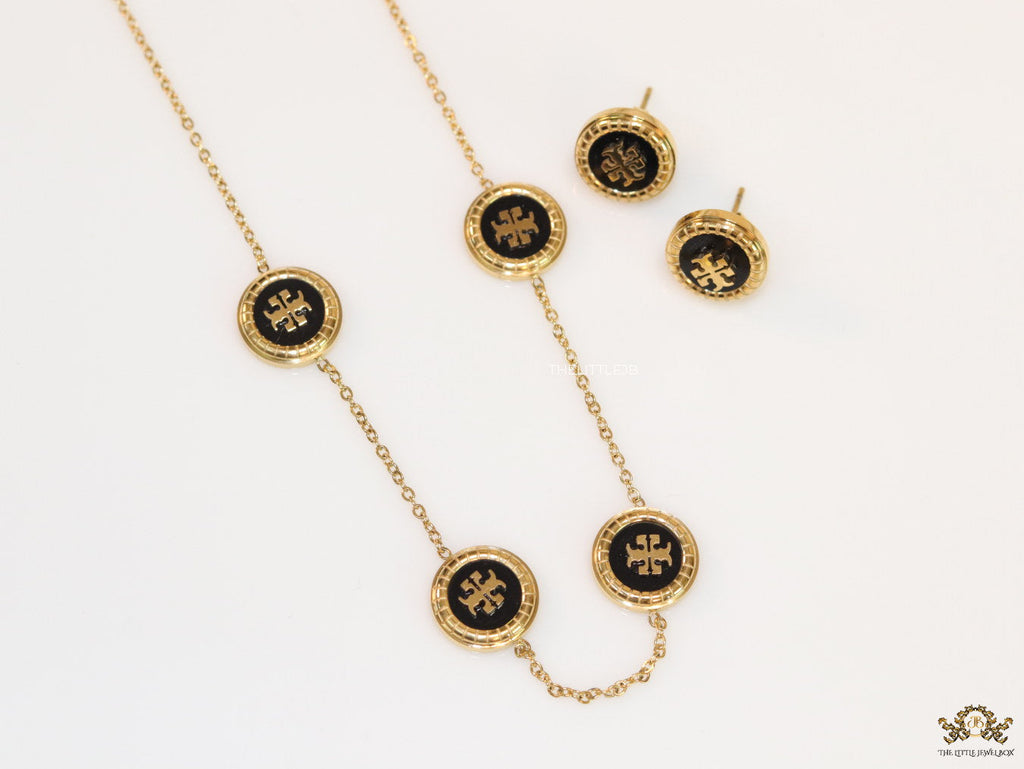 Gold plated necklace set with T motif black enamel coated discs