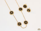 Gold plated necklace set with T motif black enamel coated discs