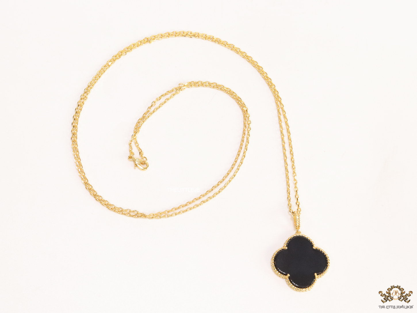 Black enamel clover pendant in gold plated chain