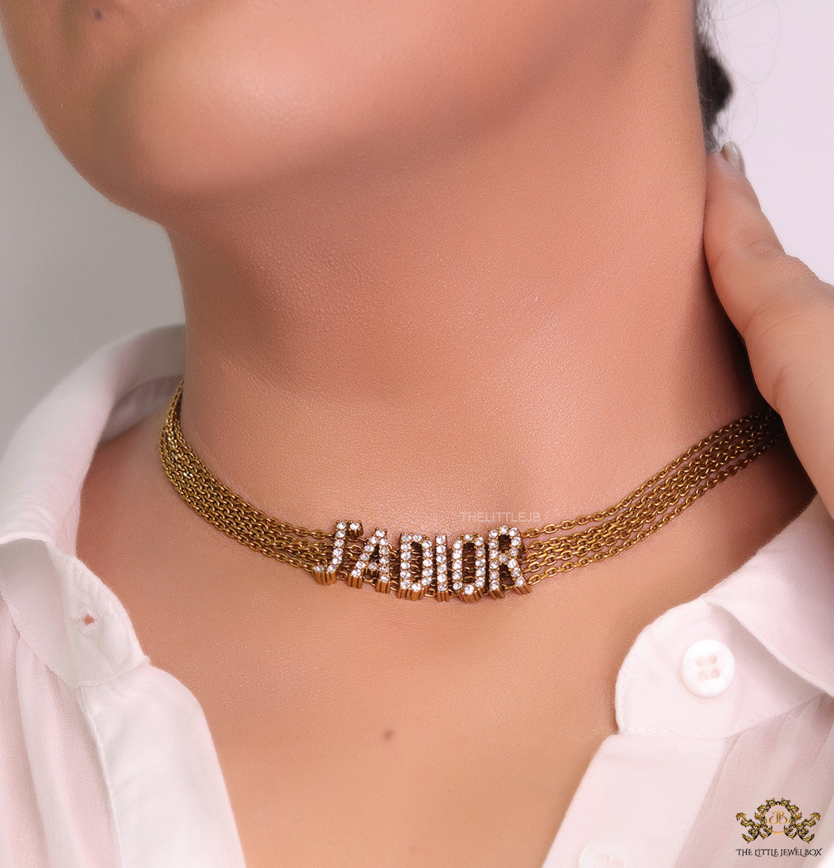 Golden multi chain choker necklace with alphabet motif in cz