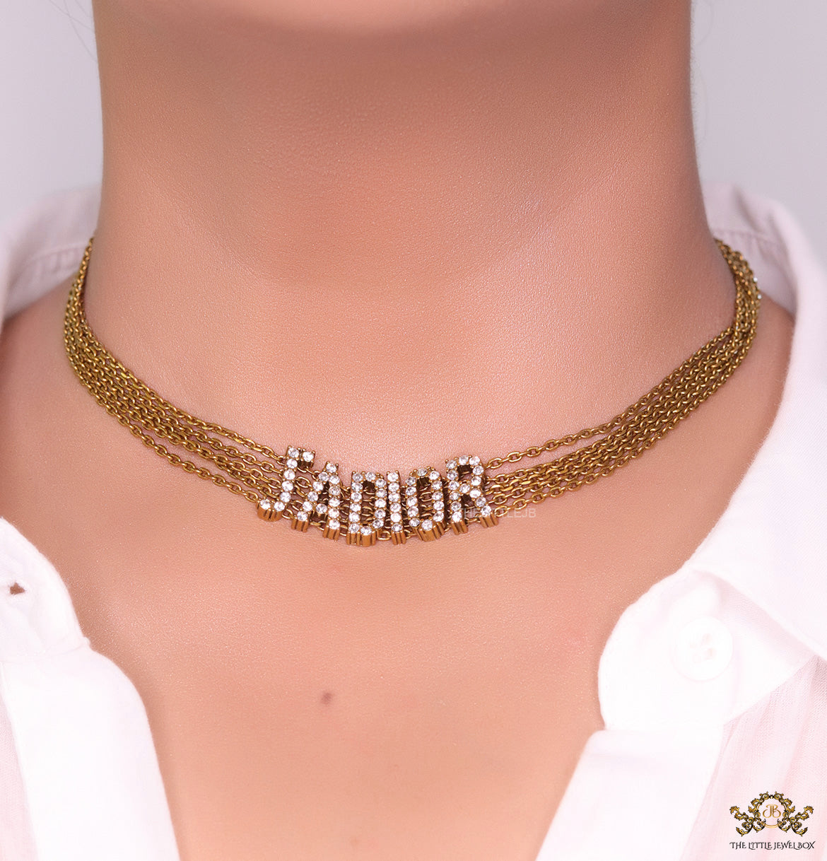 Golden multi chain choker necklace with alphabet motif in cz