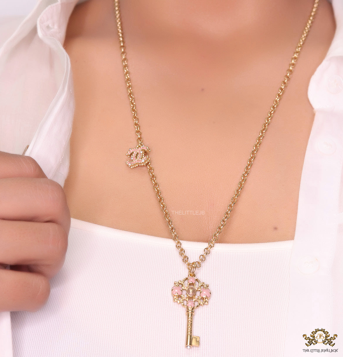 Golden chain necklace with pink clovers studded key pendant