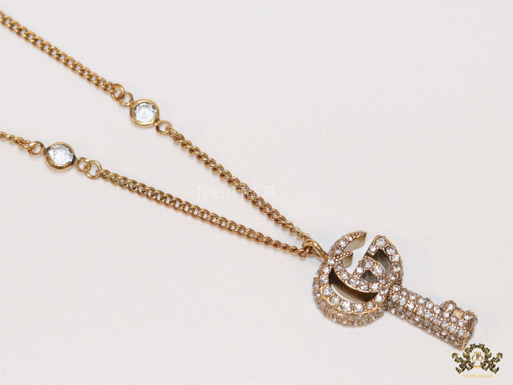 Gold plated chain necklace with cz G and key pendant