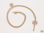 Golden chain necklace with pink clovers studded key pendant