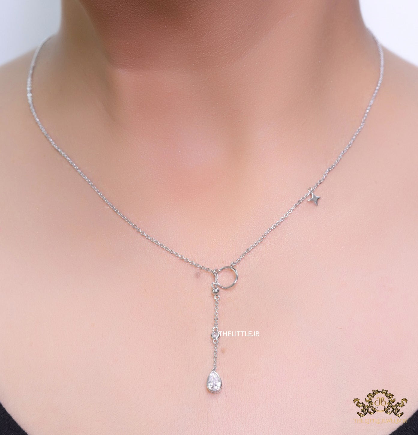 Platinum knot necklace with cz drop and small charms