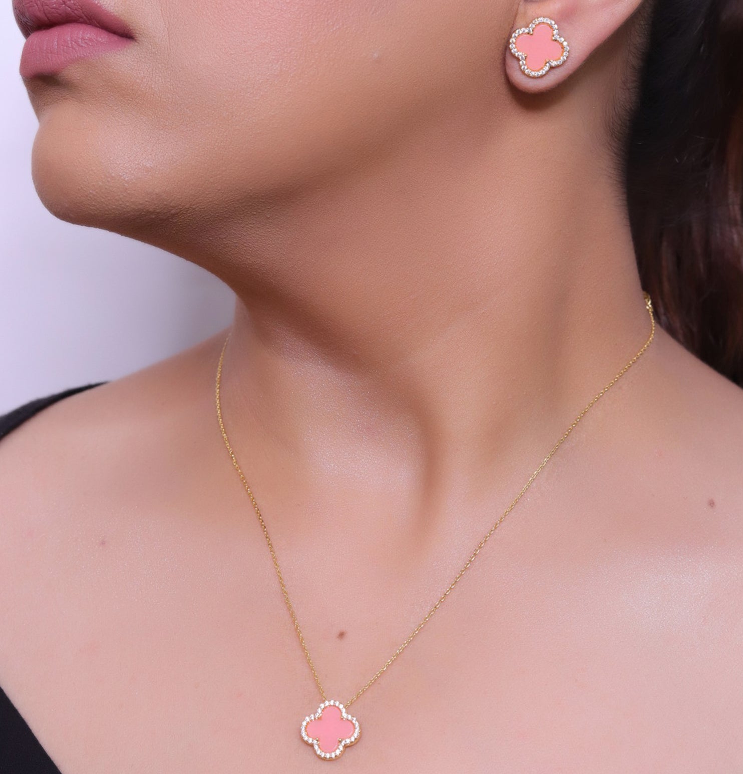 Sleek gold plated chain with cubic zirconia studded pink clover shape pendant