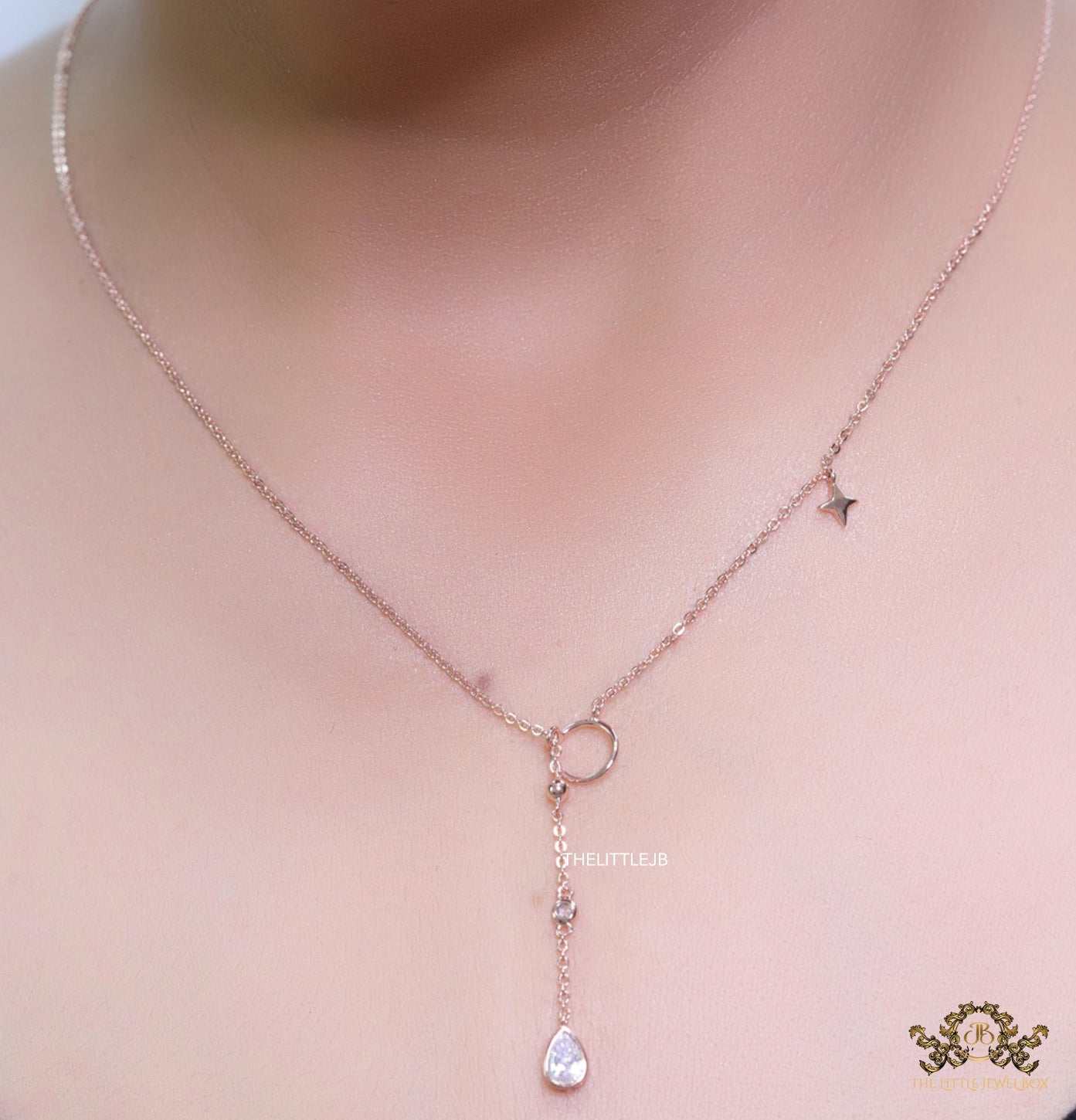 Platinum knot necklace with cz drop and small charms