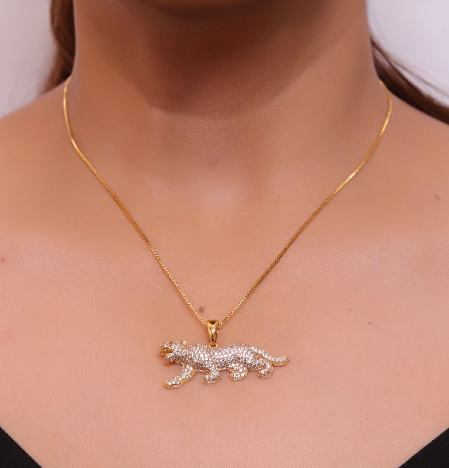 Gold plated cubic zirconia panther pendant on sleek gold plated chain