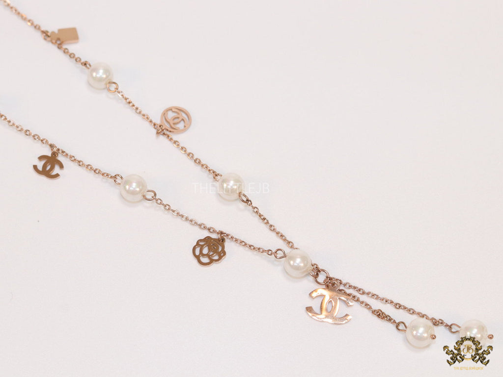 Gold chain necklace with pearls and alphabet motifs